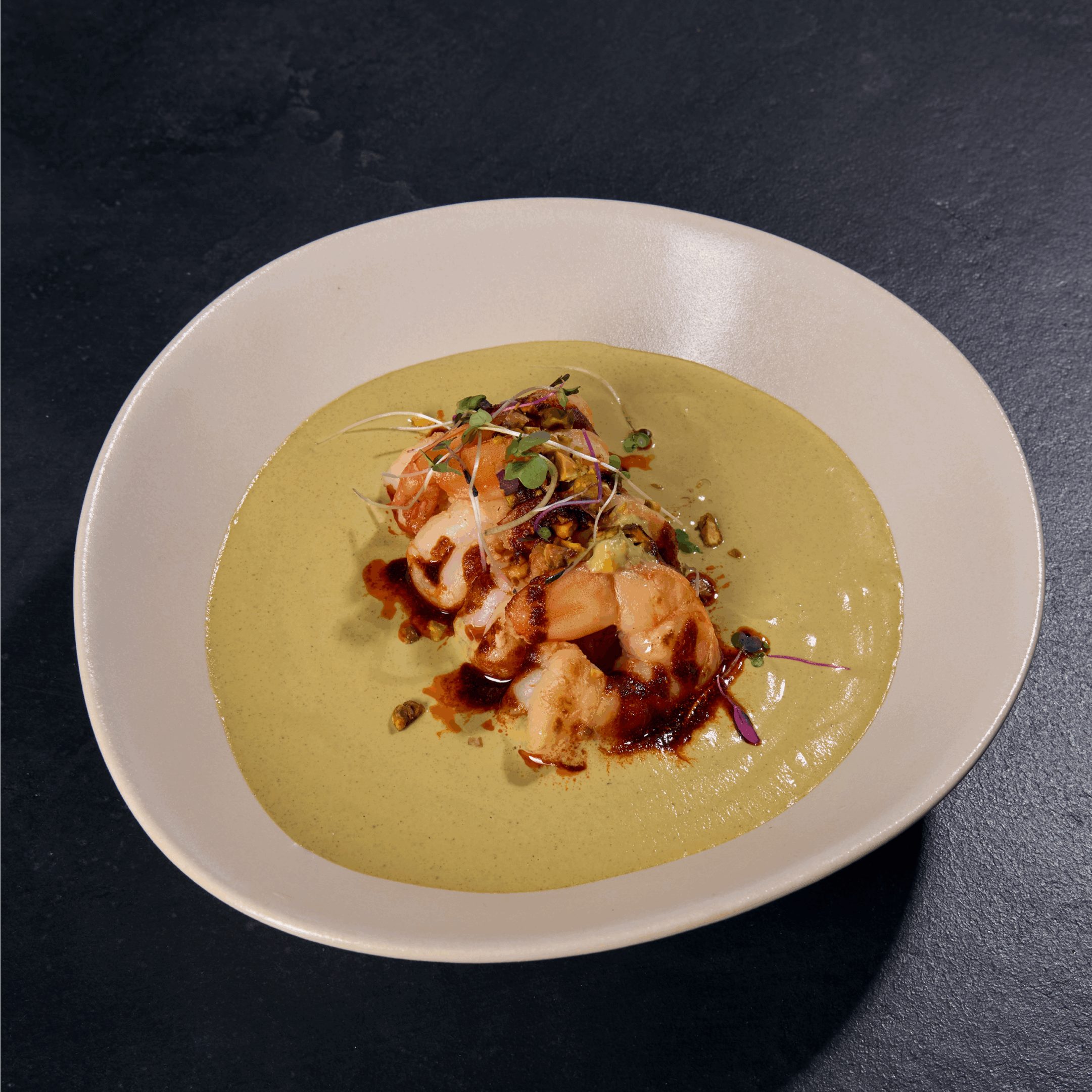 Gourmet dish with green sauce on plate.