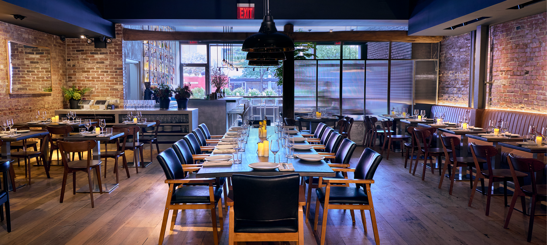 Modern restaurant interior with long dining tables.