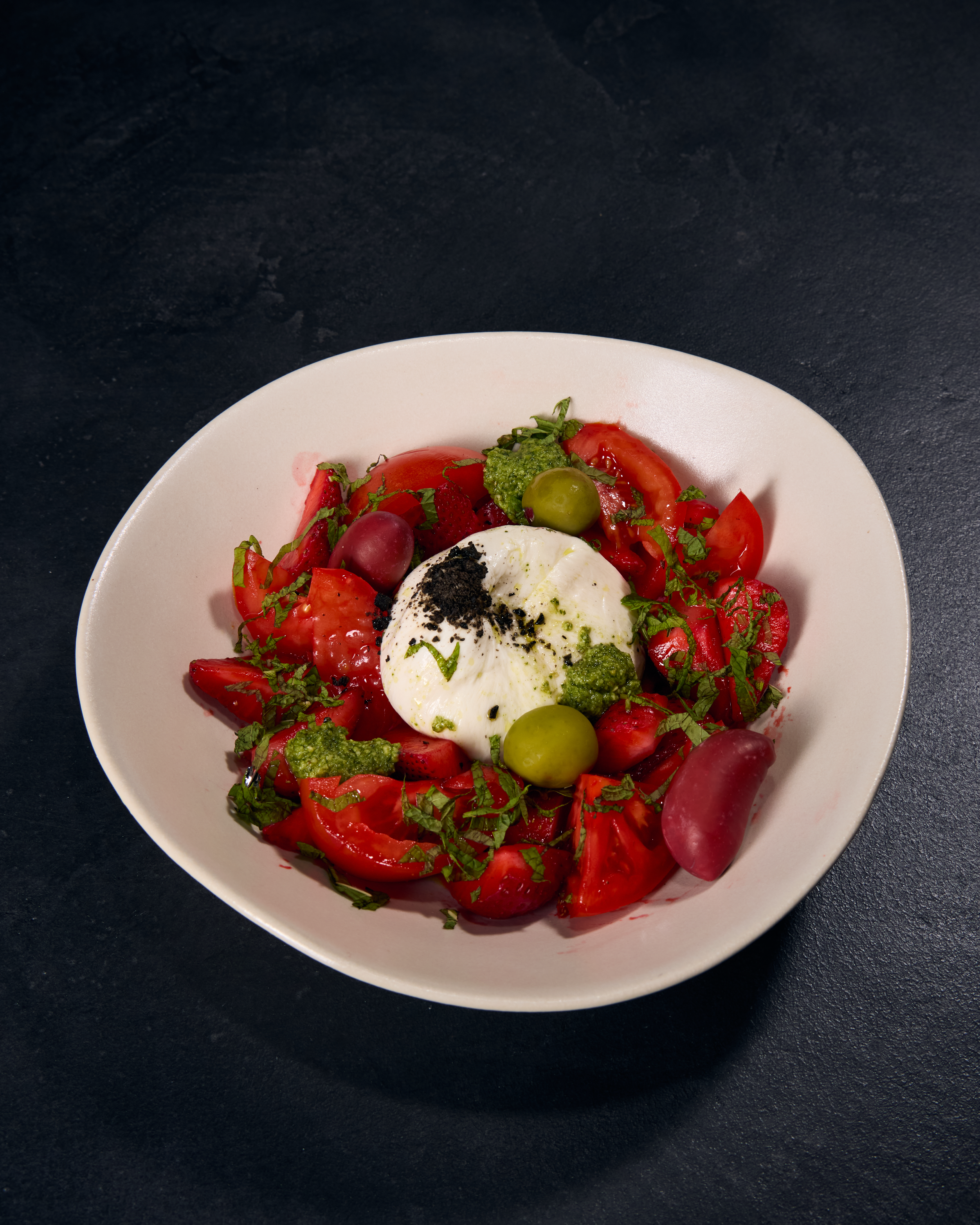Tomato salad with burrata and olives.