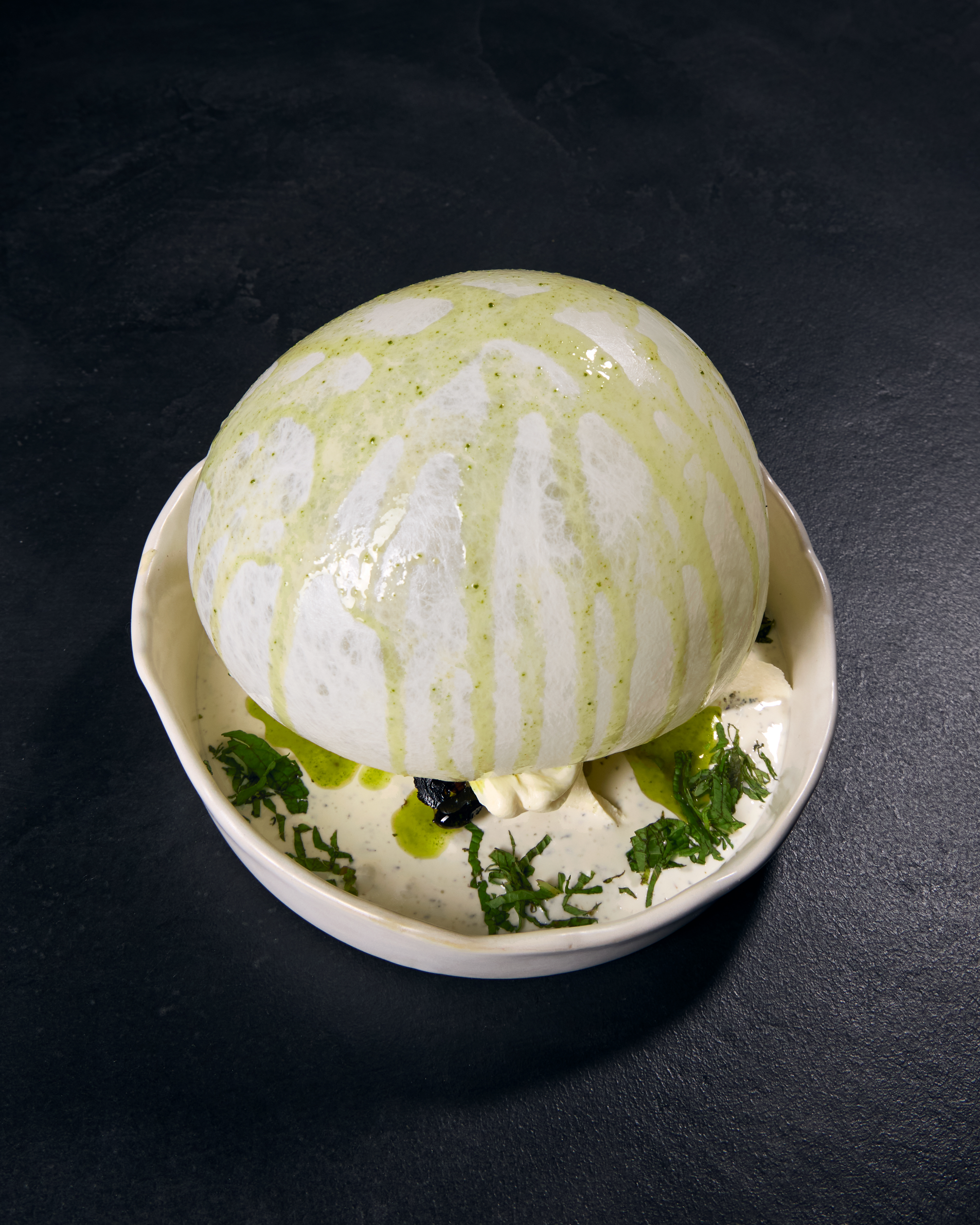 Gourmet dish with white dome presentation.