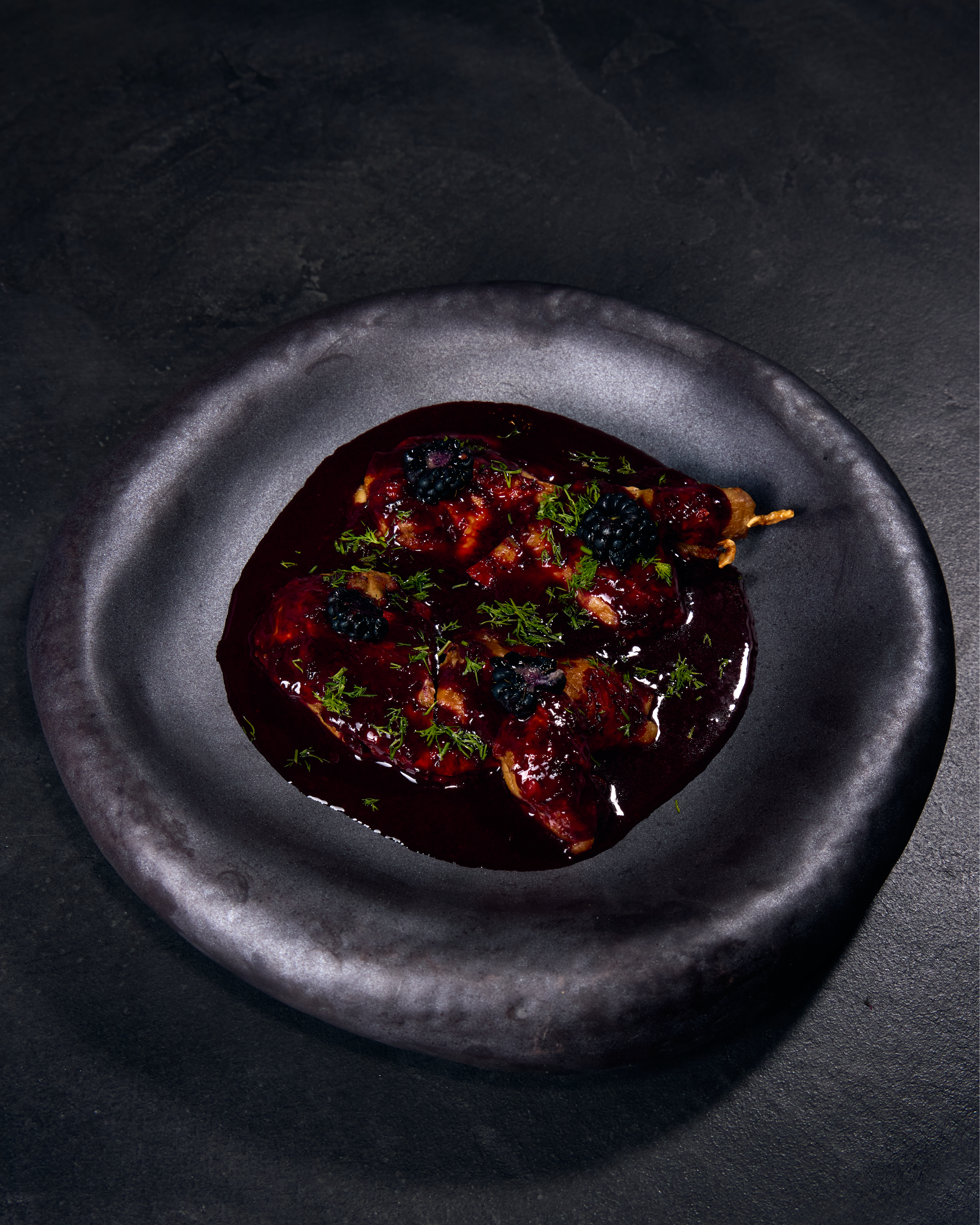 Gourmet dish with rich sauce on plate.